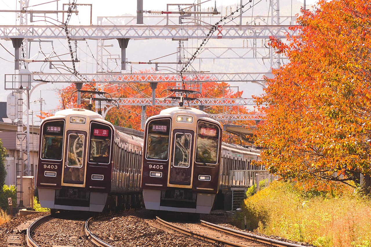 Hankyu 9300 series limited express trains passing at Nishi-Mukō Station on the Hankyu Kyoto Line.